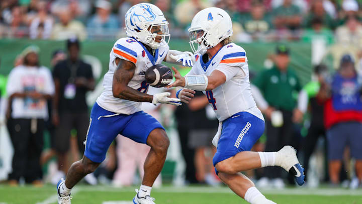 Boise State quarterback Maddux Madsen hands off to running back Malik Sharrod.