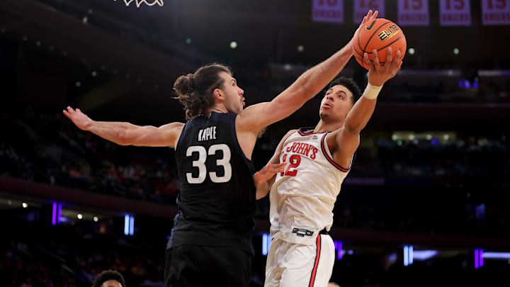 Mar 13, 2025; New York, NY, USA; St. John's Red Storm guard RJ Luis Jr. (12) drives to the basket against Butler Bulldogs forward Boden Kapke (33) during the second half at Madison Square Garden. Mandatory Credit: Brad Penner-Imagn Images