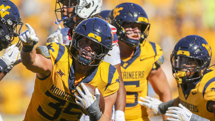 Aug 30, 2025; Morgantown, West Virginia, USA; West Virginia Mountaineers linebacker Reid Carrico (35) recovers a fumbleduring the third quarter against the Robert Morris Colonials at Milan Puskar Stadium. Mandatory Credit: Ben Queen-Imagn Images