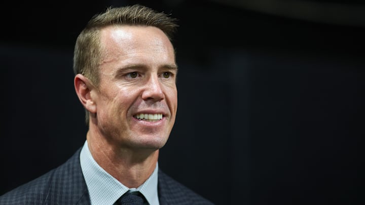 Oct 3, 2024; Atlanta, Georgia, USA; Former Atlanta Falcons quarterback Matt Ryan (2) on the sideline before being inducted in the team’s ring of honor at halftime of a game against the Tampa Bay Buccaneers at Mercedes-Benz Stadium. Mandatory Credit: Brett Davis-Imagn Images
