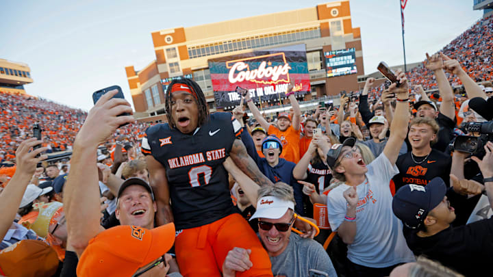 Oklahoma State Cowboys running back Ollie Gordon II (0) celebrates with fans.