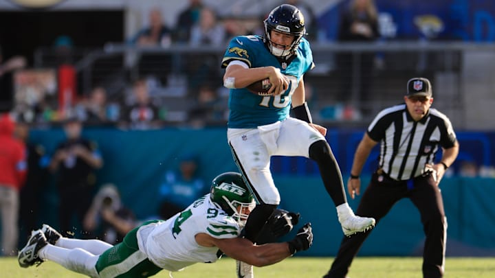 Jacksonville Jaguars quarterback Mac Jones (10) it brought down by Jacksonville Jaguars defensive tackle Maason Smith (94) during the fourth quarter Sunday, Dec. 15, 2024 at EverBank Stadium in Jacksonville, Fla. The Jets held off the Jaguars 32-25. [Corey Perrine/Florida Times-Union]