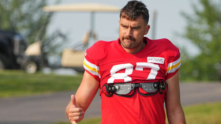 Jul 26, 2024; Kansas City, MO, USA; Kansas City Chiefs tight end Travis Kelce (87) waves to fans as he walks down the hill from the locker room to the fields prior to training camp at Missouri Western State University. Mandatory Credit: Denny Medley-USA TODAY Sports