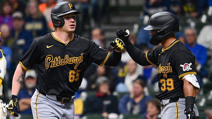 Pittsburgh Pirates left fielder Jack Suwinski (65) is greeted by second baseman Nick Gonzales (39) after hitting a 2-run home run in the first inning against the Milwaukee Brewers at American Family Field. 
