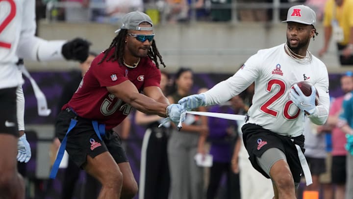 Feb 2, 2025; Orlando, FL, USA; AFC running back Joe Mixon of the Houston Texans (28) carries the ball against NFC linebacker Fred Warner of the San Francisco 49ers (54) during the 2025 Pro Bowl Games at Camping World Stadium. Mandatory Credit: Kirby Lee-Imagn Images Feb 2, 2025; Orlando, FL, USA; AFC running back Joe Mixon of the Houston Texans (28) carries the ball against NFC linebacker Fred Warner of the San Francisco 49ers (54) during the 2025 Pro Bowl Games at Camping World Stadium. Mandatory Credit: Kirby Lee-Imagn Images