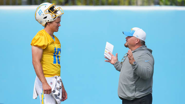 Jun 13, 2024; Costa Mesa, CA, USA; Los Angeles Chargers quarterback Justin Herbert (10) interacts with offensive coordinator Greg Roman during minicamp at the Hoag Performance Center.  Mandatory Credit: Kirby Lee-Imagn Images