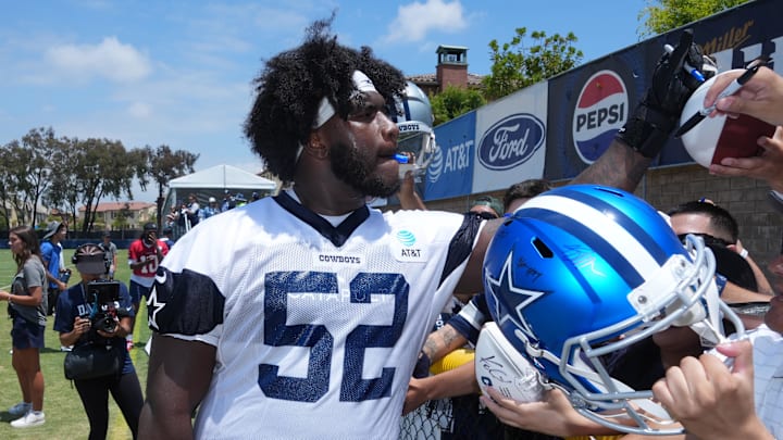 Dallas Cowboys guard Tyler Booker signs autographs during training camp at the River Ridge Fields. Dallas Cowboys guard Tyler Booker signs autographs during training camp at the River Ridge Fields.