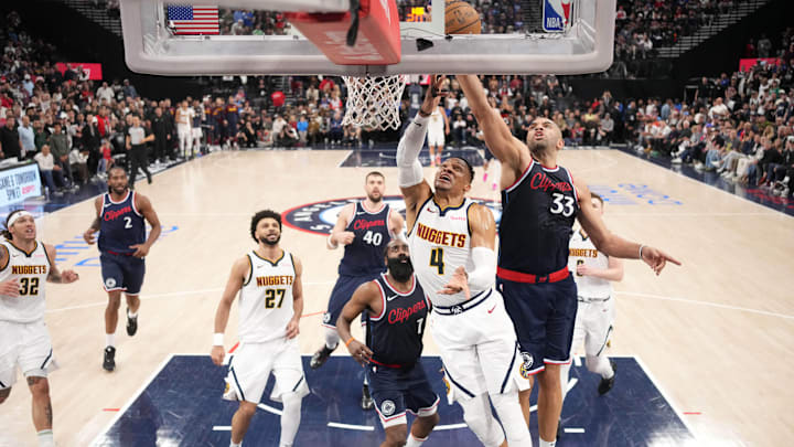 May 1, 2025; Inglewood, California, USA; LA Clippers forward Nicolas Batum (33) blocks a shot by Denver Nuggets guard Russell Westbrook (4) in the second half  during game six of first round for the 2025 NBA Playoffs at Intuit Dome. Mandatory Credit: Kirby Lee-Imagn Images