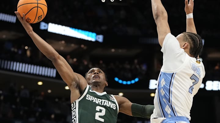 March 23, 2024, Charlotte, NC, USA; Michigan State Spartans guard Tyson Walker (2) shoots against North Carolina Tar Heels guard Seth Trimble (7)  in the second round of the 2024 NCAA Tournament at the Spectrum Center. Mandatory Credit: Bob Donnan-Imagn Images