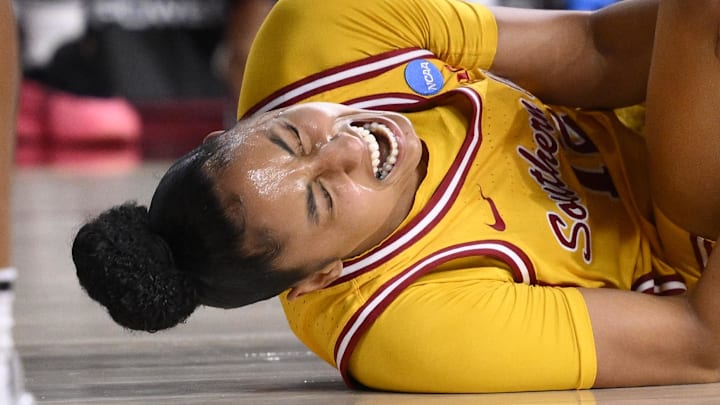 Mar 24, 2025; Los Angeles, California, USA; USC Trojans guard JuJu Watkins (12) grabs her knee after falling to the floor during an NCAA Tournament second round game against the Mississippi State Bulldogs at Galen Center. Mandatory Credit: Robert Hanashiro-Imagn Images