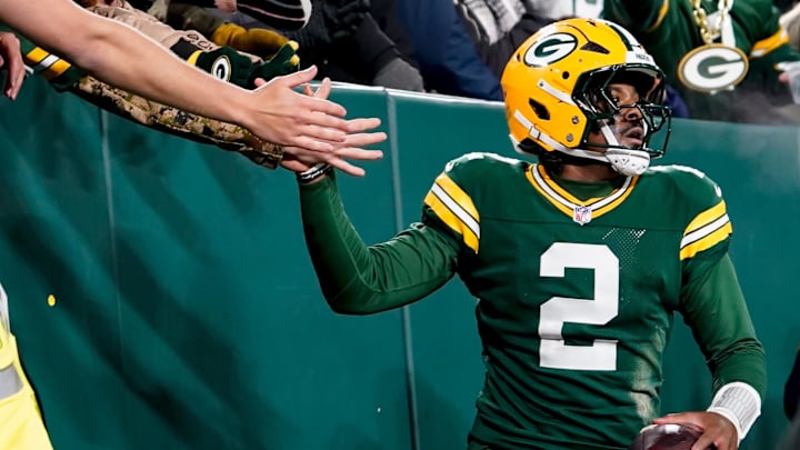 Dec 27, 2025; Green Bay, Wisconsin, USA; Green Bay Packers quarterback Malik Willis (2) high-fives fans after a touchdown during the third quarter against the Baltimore Ravens at Lambeau Field. 
