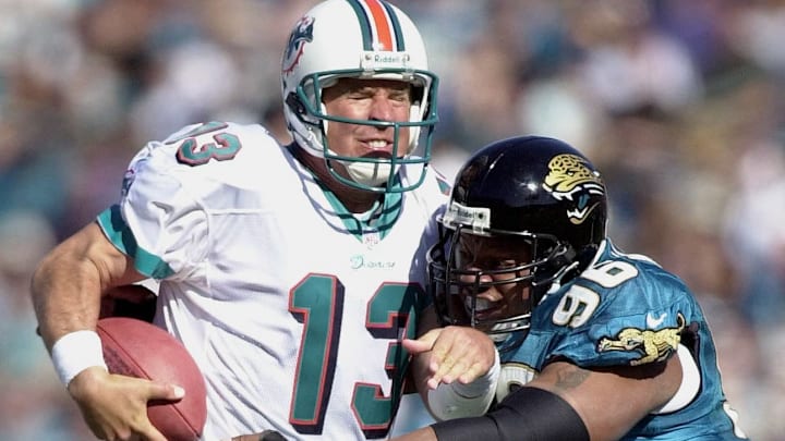 Miami Dolphins quarterback Dan Marino (L) is sacke