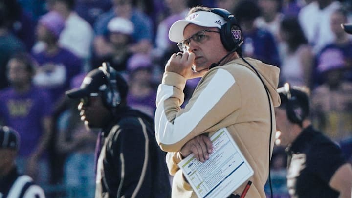 Jedd Fisch, holding his play call sheet, ponders a game-day decision.