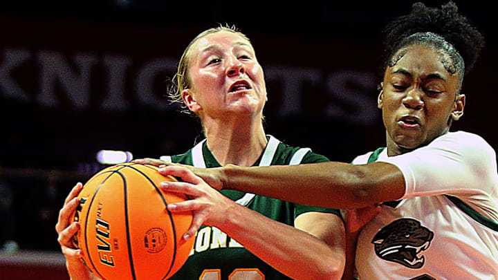 New Providence's Annie Conover goes to the basket as Newark Arts' Ruqayyah Perez defends in the Group 1 girls basketball final at Rutgers' Jersey Mike's Arena on March 15, 2026.