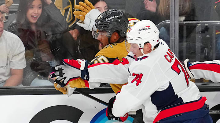 Nov 17, 2024; Las Vegas, Nevada, USA; Washington Capitals defenseman John Carlson (74) gloves a loose puck beside Vegas Golden Knights right wing Keegan Kolesar (55) during the third period at T-Mobile Arena. Mandatory Credit: Stephen R. Sylvanie-Imagn Images Nov 17, 2024; Las Vegas, Nevada, USA; Washington Capitals defenseman John Carlson (74) gloves a loose puck beside Vegas Golden Knights right wing Keegan Kolesar (55) during the third period at T-Mobile Arena. Mandatory Credit: Stephen R. Sylvanie-Imagn Images
