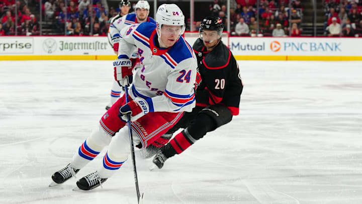 May 11, 2024; Raleigh, North Carolina, USA; New York Rangers right wing Kaapo Kakko (24) skates with the puck against Carolina Hurricanes center Sebastian Aho (20) during the second period in game four of the second round of the 2024 Stanley Cup Playoffs at PNC Arena. Mandatory Credit: James Guillory-Imagn Images