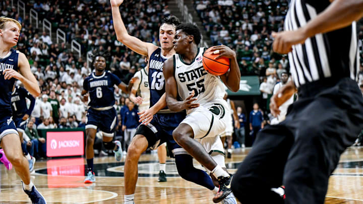 Michigan State's Coen Carr, right, moves the ball as Monmouth's Jack Collins defends during the second half on Monday, Nov. 4, 2024, at the Breslin Center in East Lansing.
