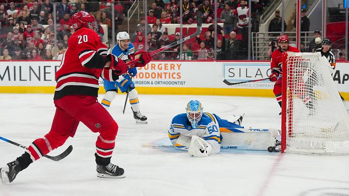 Mar 12, 2026; Raleigh, North Carolina, USA;  St. Louis Blues goaltender Jordan Binnington (50) stops the shot by Carolina Hurricanes center Sebastian Aho (20) during the third period at Lenovo Center. Mandatory Credit: James Guillory-Imagn Images