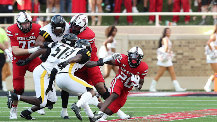 Aug 30, 2025; Lubbock, Texas, USA;  Texas Tech Red Raiders running back J’Koby Williams (20) rushes against Arkansas-Pine Bluff Golden Lions defensive safety Kyle Knox (27) in the first half at Jones AT&T Stadium. Mandatory Credit: Michael C. Johnson-Imagn Images