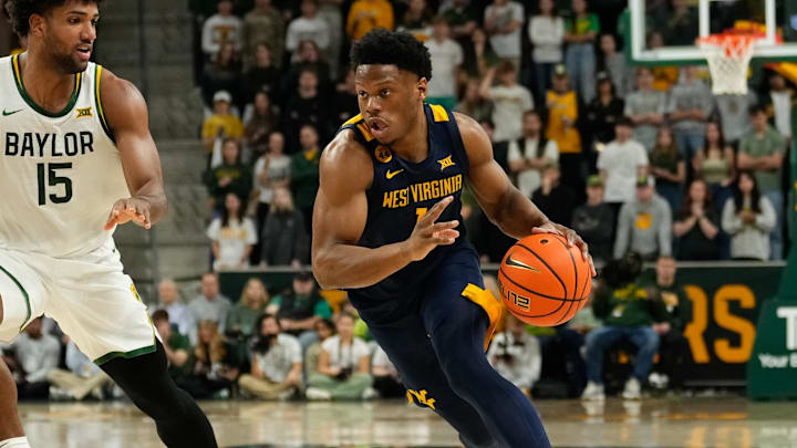 Feb 15, 2025; Waco, Texas, USA; West Virginia Mountaineers guard Joseph Yesufu (1) drives to the basket ahead of Baylor Bears forward Norchad Omier (15) during the first half at Paul and Alejandra Foster Pavilion. Mandatory Credit: Chris Jones-Imagn Images