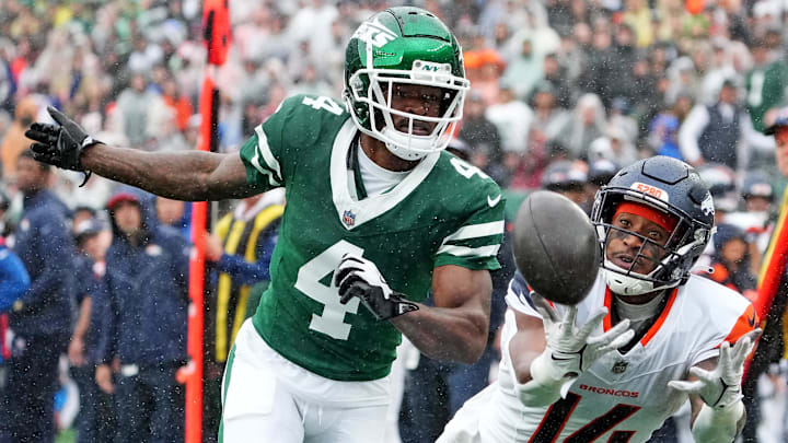 Sep 29, 2024; East Rutherford, New Jersey, USA;  Denver Broncos wide receiver Courtland Sutton (14) can not hang on to a pass as New York Jets cornerback D.J. Reed (4) defends during the first quarter at MetLife Stadium. 