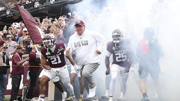 Dec 20, 2025; College Station, TX, USA; Texas A&M Aggies head coach Mike Elko takes the field prior to the game against the Miami Hurricanes during the first round of the CFP National Playoff at Kyle Field. Mandatory Credit: Maria Lysaker-Imagn Images