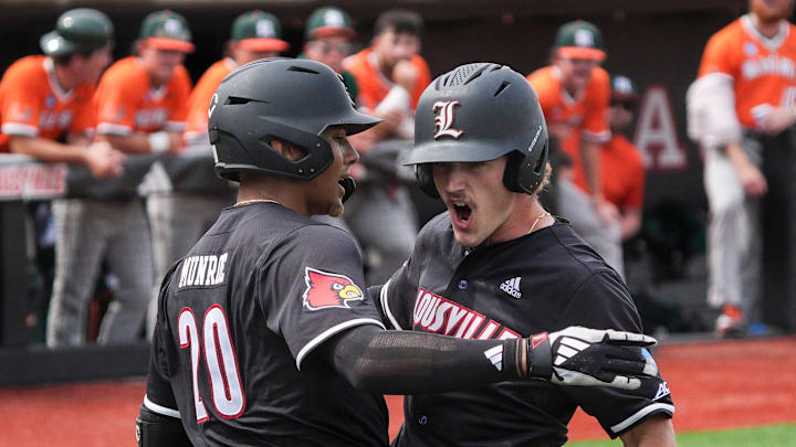 Louisville outfielder Garret Pike (2), right, celebrates while getting a hug from teammate and on-deck batter Jake Munroe (20) after hitting a home run to put the Cards up 1-0 over Miami in the NCAA baseball Super Regional game Friday afternoon. June 6, 2025
