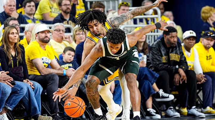 Michigan guard Elliot Cadeau (3) tries to steal the ball from Michigan State guard Jeremy Fears Jr. (1) during the first half at Crisler Center in Ann Arbor on Sunday, March 8, 2026.