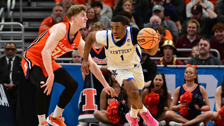 Mar 23, 2025; Milwaukee, WI, USA;  Kentucky Wildcats guard Lamont Butler (1) dribbles against Illinois Fighting Illini guard Kasparas Jakucionis (32) during the second half in the second round of the NCAA Tournament at Fiserv Forum. Mandatory Credit: Benny Sieu-Imagn Images