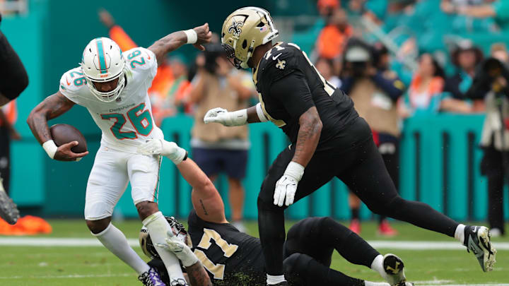 Miami Dolphins cornerback Rasul Douglas (26) carries the ball after making an interception as New Orleans Saints offensive tackle Dillon Radunz (77) attempts to make the tackle during the first half at Hard Rock Stadium.