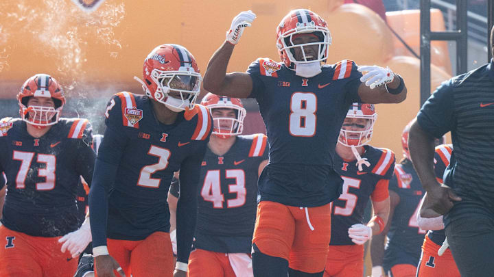 Dec 31, 2024; Orlando, FL, USA; Illinois Fighting Illini wide receiver Malik Elzy (8) and Illinois Fighting Illini wide receiver Ashton Hollins (2) lead the team out of the tunnel before the game against the South Carolina Gamecocks at Camping World Stadium. Mandatory Credit: Jeremy Reper-Imagn Images Dec 31, 2024; Orlando, FL, USA; Illinois Fighting Illini wide receiver Malik Elzy (8) and Illinois Fighting Illini wide receiver Ashton Hollins (2) lead the team out of the tunnel before the game against the South Carolina Gamecocks at Camping World Stadium. Mandatory Credit: Jeremy Reper-Imagn Images