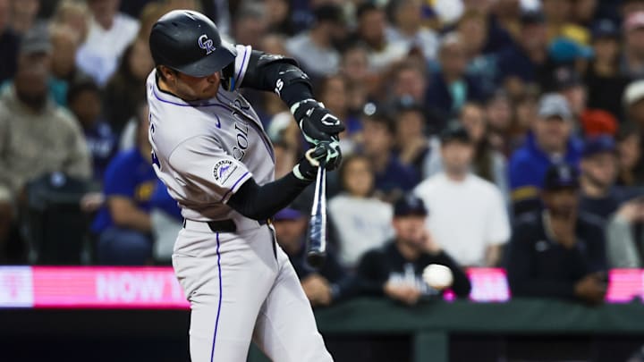 Sep 23, 2025; Seattle, Washington, USA; Colorado Rockies third baseman Kyle Karros (12) hits an RBI-infield single against the Seattle Mariners during the second inning at T-Mobile Park. 