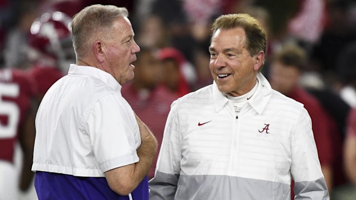 Nov 4, 2023; Tuscaloosa, Alabama, USA;  LSU Tigers head coach Brian Kelly and Alabama Crimson Tide head coach Nick Saban talk together at midfield before the Alabama vs LSU game at Bryant-Denny Stadium. Mandatory Credit: Gary Cosby Jr.-Imagn Images