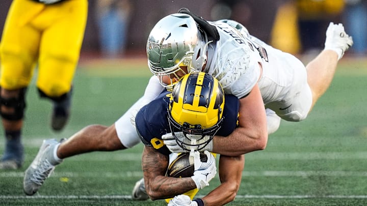 Michigan wide receiver Tyler Morris (8) is tackled by Oregon linebacker Bryce Boettcher (28) during the second half at Michigan Stadium in Ann Arbor on Saturday, Nov. 2, 2024.