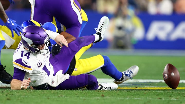 Jan 13, 2025; Glendale, AZ, USA; Minnesota Vikings quarterback Sam Darnold (14) is sacked by Los Angeles Rams cornerback Ahkello Witherspoon (4) during the first half in an NFC wild card game at State Farm Stadium. Mandatory Credit: Mark J. Rebilas-Imagn Images Jan 13, 2025; Glendale, AZ, USA; Minnesota Vikings quarterback Sam Darnold (14) is sacked by Los Angeles Rams cornerback Ahkello Witherspoon (4) during the first half in an NFC wild card game at State Farm Stadium. Mandatory Credit: Mark J. Rebilas-Imagn Images
