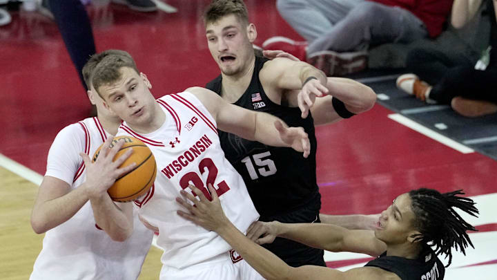 Wisconsin forward Aleksas Bieliauskas (32) out rebounds Michigan State center Carson Cooper (15) during the first half of their game Friday, February 13, 2026 at the Kohler Center in Madison.