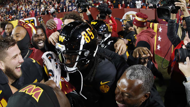 Oct 27, 2024; Landover, Maryland, USA; Washington Commanders wide receiver Noah Brown (85) celebrates with teammates after catching a game-winnning Hail Mary pass on the final play of the game against the Chicago Bears at Northwest Stadium. Mandatory Credit: Geoff Burke-Imagn Images