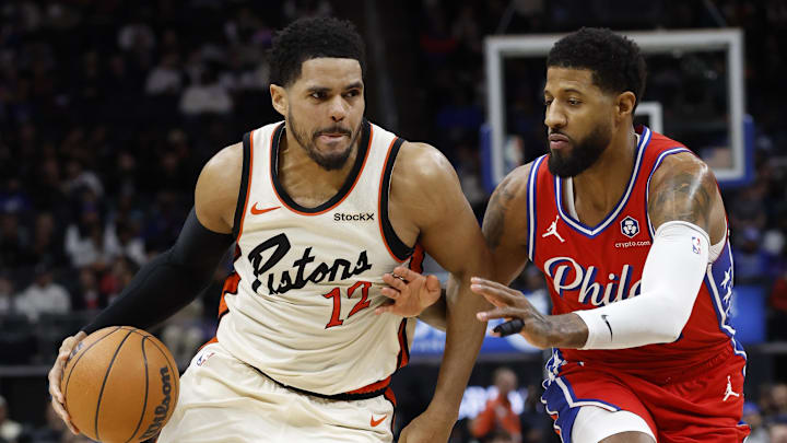 Feb 7, 2025; Detroit, Michigan, USA;  Detroit Pistons forward Tobias Harris (12) dribbles defended by Philadelphia 76ers forward Paul George (8) in the second half at Little Caesars Arena. Mandatory Credit: Rick Osentoski-Imagn Images