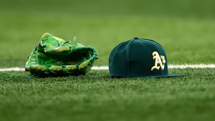 Jul 22, 2025; Arlington, Texas, USA; Athletics glove and hat on the field before the game against the Texas Rangers at Globe Life Field. Mandatory Credit: Kevin Jairaj-Imagn Images Jul 22, 2025; Arlington, Texas, USA; Athletics glove and hat on the field before the game against the Texas Rangers at Globe Life Field. Mandatory Credit: Kevin Jairaj-Imagn Images