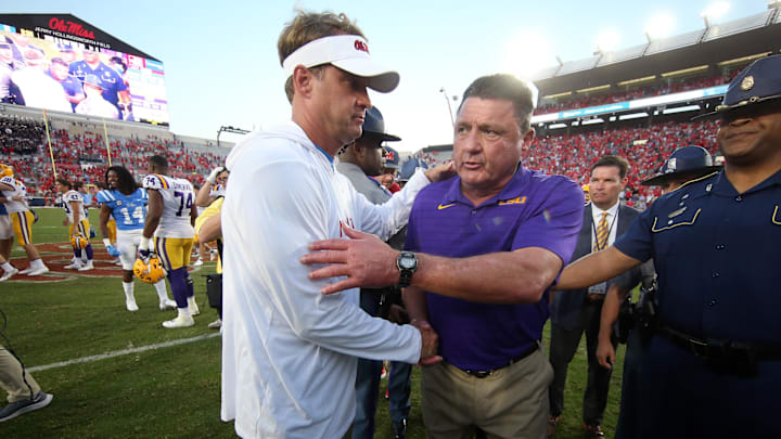 Oct 23, 2021; Oxford, Mississippi, USA; Mississippi Rebels head coach Lane Kiffin (left) and LSU Tigers head coach Ed Orgeron (right) shake hands after a game at Vaught-Hemingway Stadium. Mandatory Credit: Petre Thomas-Imagn Images Oct 23, 2021; Oxford, Mississippi, USA; Mississippi Rebels head coach Lane Kiffin (left) and LSU Tigers head coach Ed Orgeron (right) shake hands after a game at Vaught-Hemingway Stadium. Mandatory Credit: Petre Thomas-Imagn Images