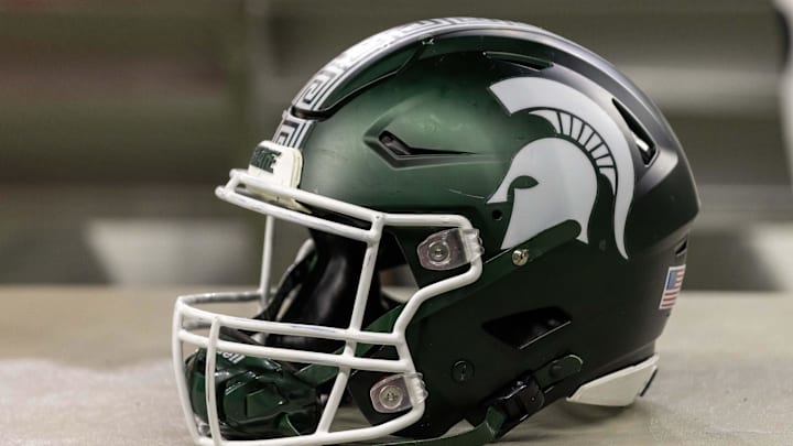 Nov 24, 2023; Detroit, Michigan, USA; A Michigan State Spartans helmet sits on a bench during the second half game against the Penn State Nittany Lions at Ford Field. Mandatory Credit: David Reginek-Imagn Images Nov 24, 2023; Detroit, Michigan, USA; A Michigan State Spartans helmet sits on a bench during the second half game against the Penn State Nittany Lions at Ford Field. Mandatory Credit: David Reginek-Imagn Images