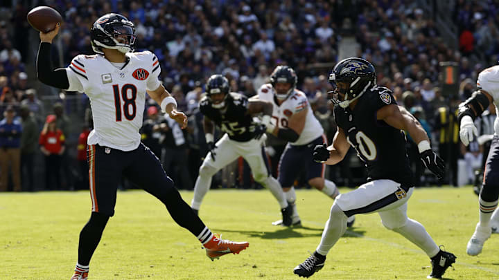 Oct 26, 2025; Baltimore, Maryland, USA; Chicago Bears quarterback Caleb Williams (18) passes the ball under pressure from Baltimore Ravens linebacker Teddye Buchanan (40) at M&T Bank Stadium. Mandatory Credit: Geoff Burke-Imagn Images