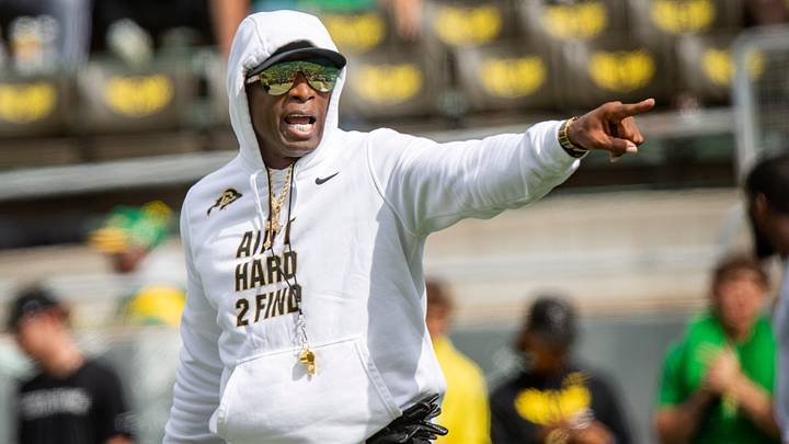 Deion Sanders walks the field during warmups before Colorado's game against Oregon.