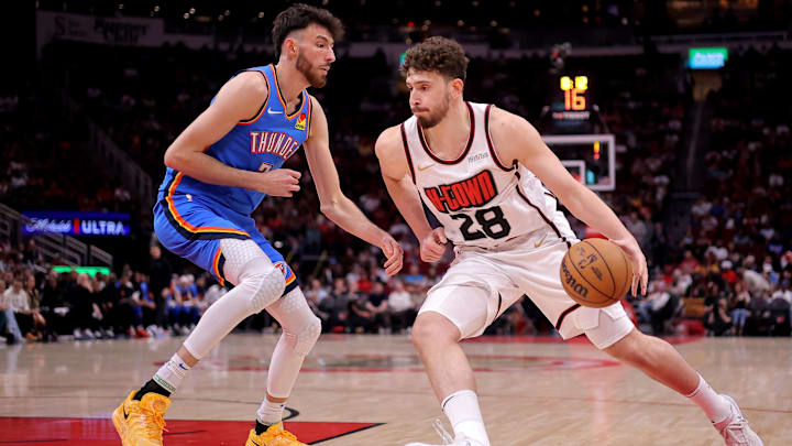 Apr 4, 2025; Houston, Texas, USA; Houston Rockets center Alperen Sengun (28) handles the ball against Oklahoma City Thunder forward Chet Holmgren (7) during the first quarter at Toyota Center. Mandatory Credit: Erik Williams-Imagn Images