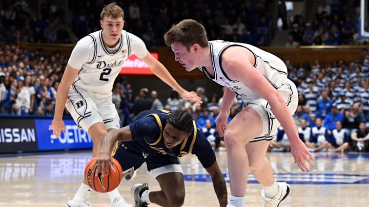Jan 11, 2025; Durham, North Carolina, USA;  Notre Dame Fighting Irish guard Markus Burton (3) loses control of the ball in front of Duke Blue Devils forward Kon Knueppel (7) during the first half at Cameron Indoor Stadium.