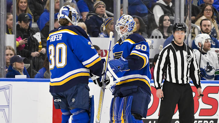 Jan 27, 2025; St. Louis, Missouri, USA;  St. Louis Blues goaltender Jordan Binnington (50) is replaced by goaltender Joel Hofer (30) during the second period against the Vancouver Canucks at Enterprise Center. Mandatory Credit: Jeff Curry-Imagn Images