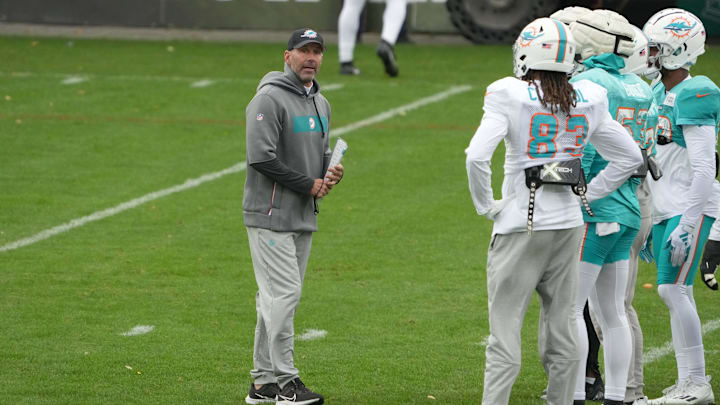 Miami Dolphins special teams coordinator Danny Crossman (left) talks with wide receiver Raleigh Webb (83) and linebacker Cameron Goode (53) during practice at the PSD Bank Arena in Germany in 2023. Miami Dolphins special teams coordinator Danny Crossman (left) talks with wide receiver Raleigh Webb (83) and linebacker Cameron Goode (53) during practice at the PSD Bank Arena in Germany in 2023.
