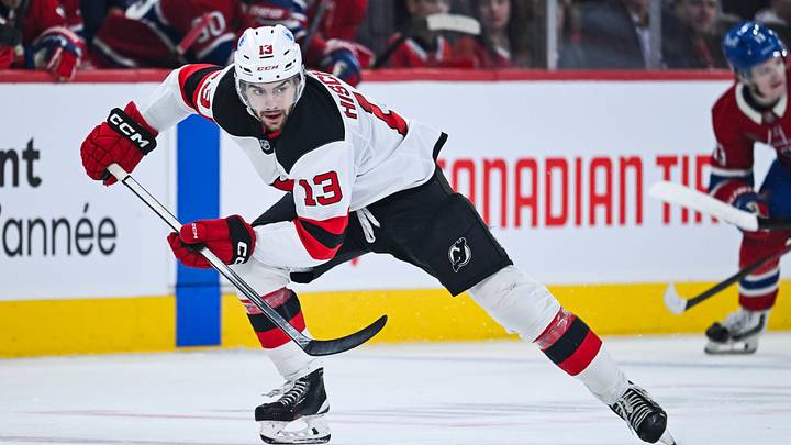 Apr 5, 2026; Montreal, Quebec, CAN; New Jersey Devils center Nico Hischier (13) plays the puck against the Montreal Canadiens during the second period at Bell Centre. Mandatory Credit: David Kirouac-Imagn Images