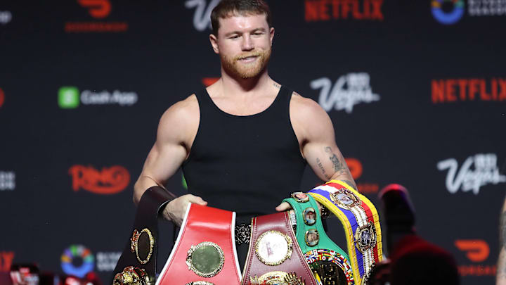 Canelo Alvarez with his belts.