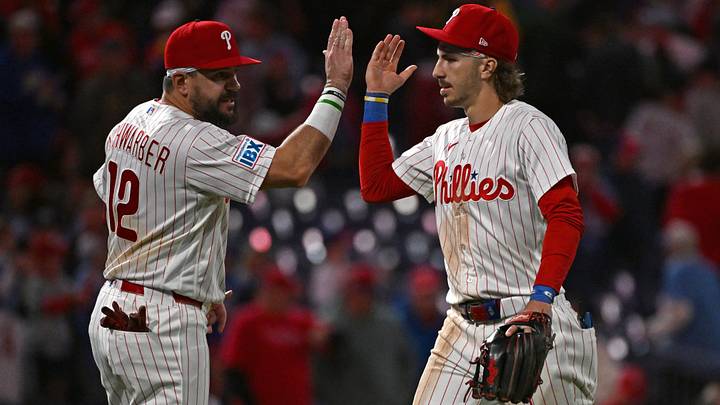Sep 22, 2026; Philadelphia, Pennsylvania, USA;  Philadelphia Phillies designated hitter Kyle Schwarber (12) and second baseman Bryson Stott (5) celebrate win against the Milwaukee Brewers at Citizens Bank Park. Mandatory Credit: Eric Hartline-Imagn Images